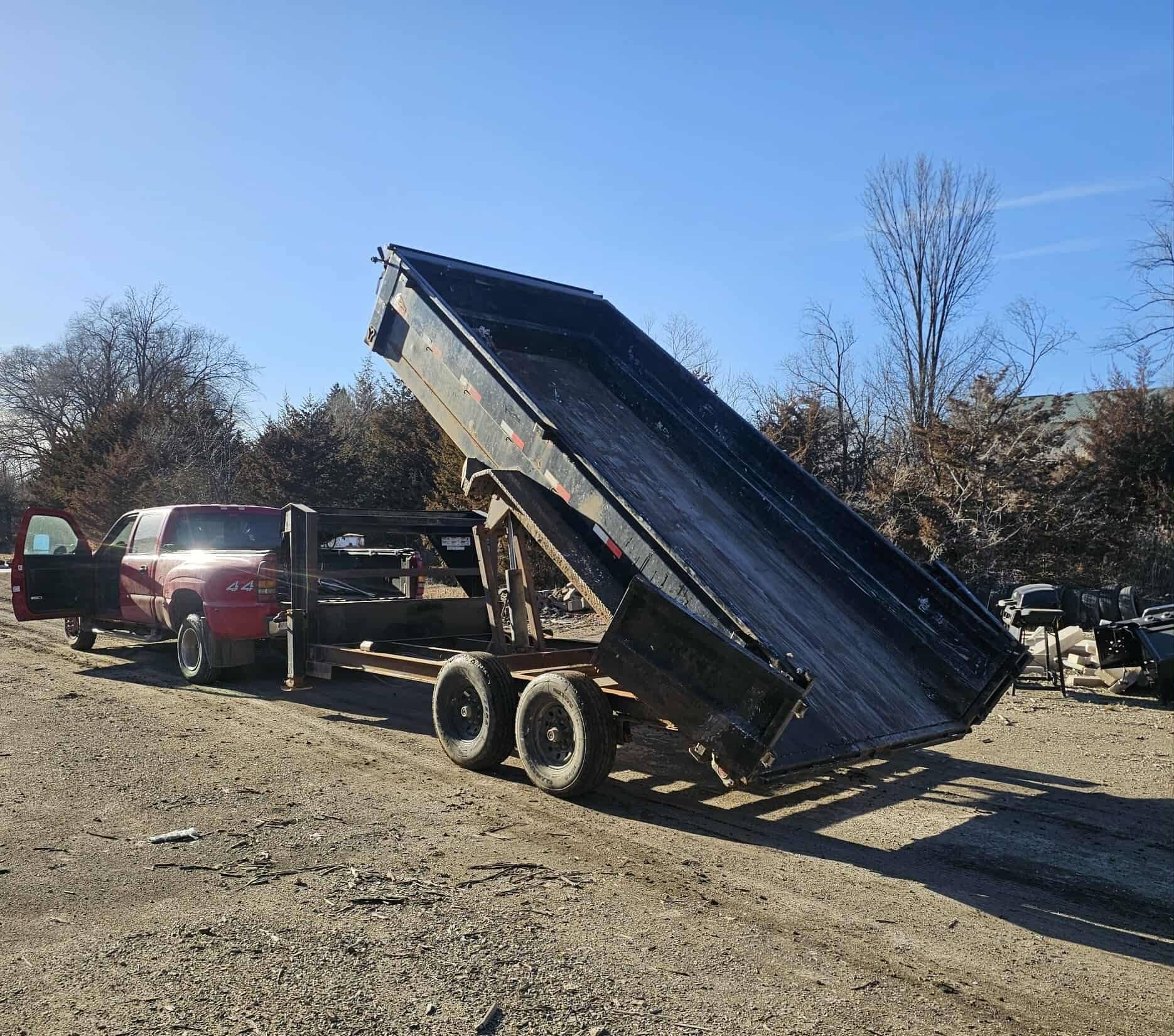 Dump trailer raised to unload construction debris