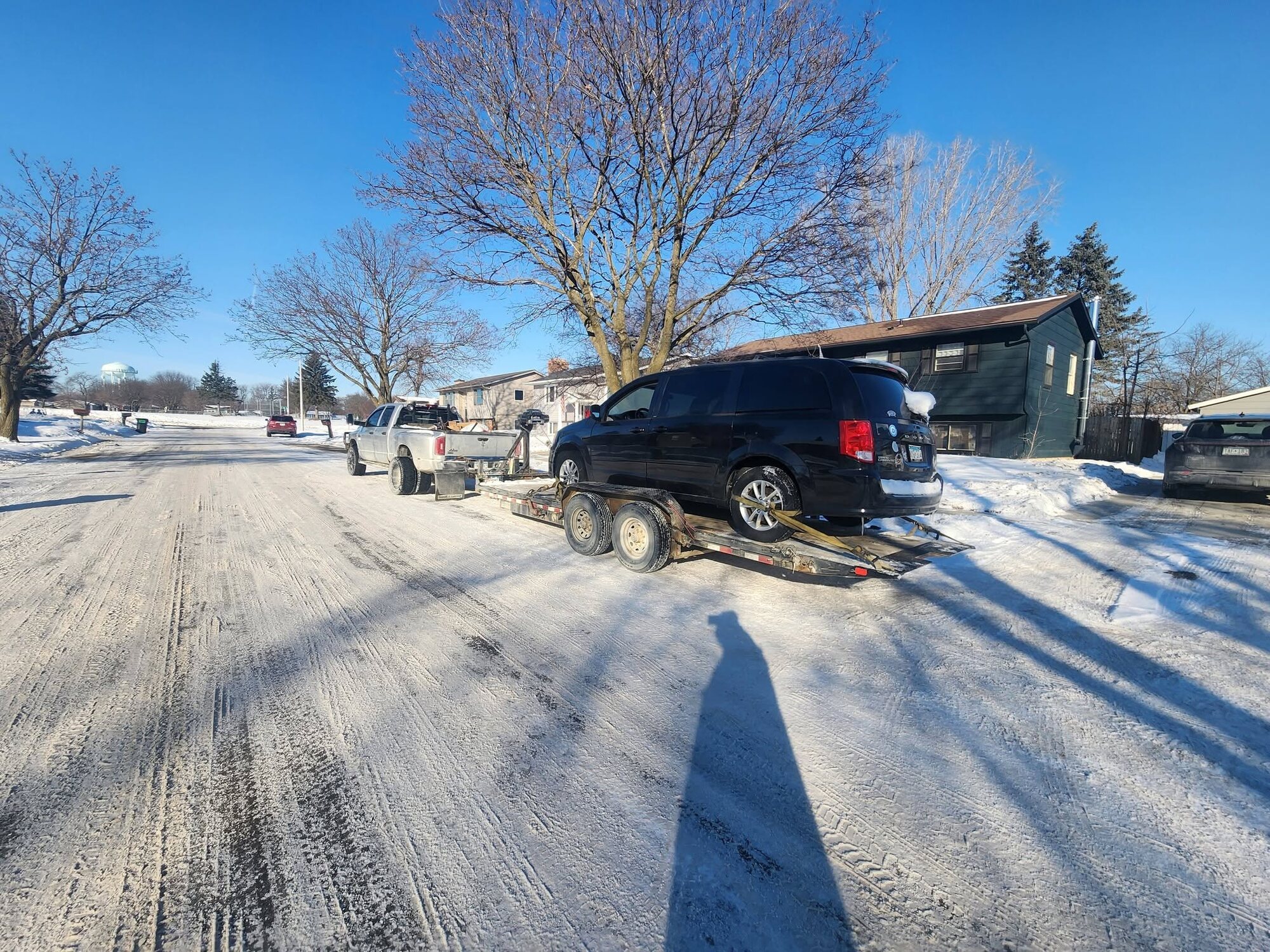 Ochoa's truck hauling a minivan on a winter street in Southern Minnesota