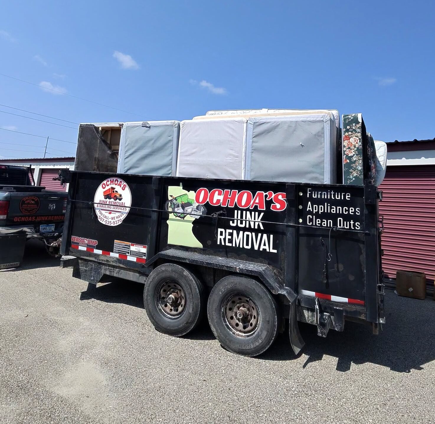 Ochoa's dump trailer loaded with mattresses and furniture after a cleanout