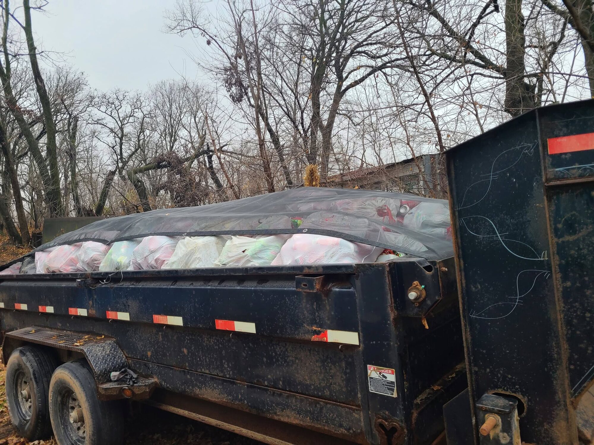 Tarped junk load secured in the dump trailer